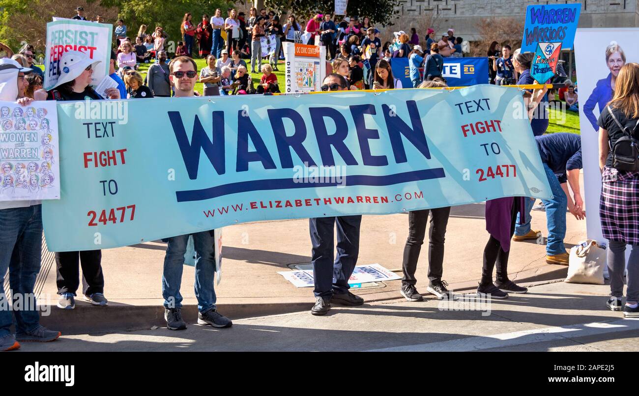 Large group of supporters for Presidential Candidate, Elizabeth Warren, hold a big banner and signs promoting Warren at the OC Women's March 2020. Stock Photo