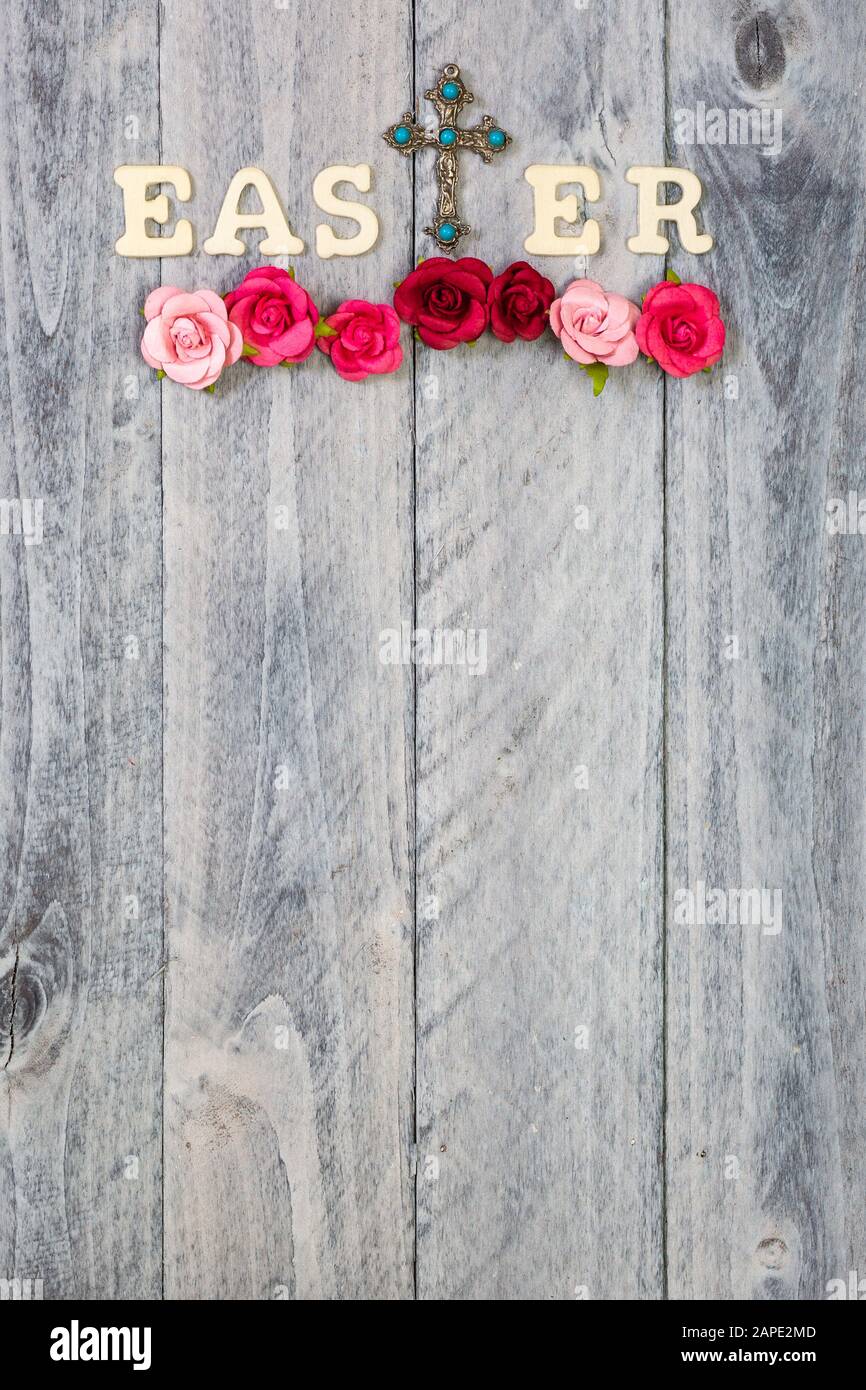 Wood background with Easter, cross and flowers with plenty of copy space, vertical Stock Photo