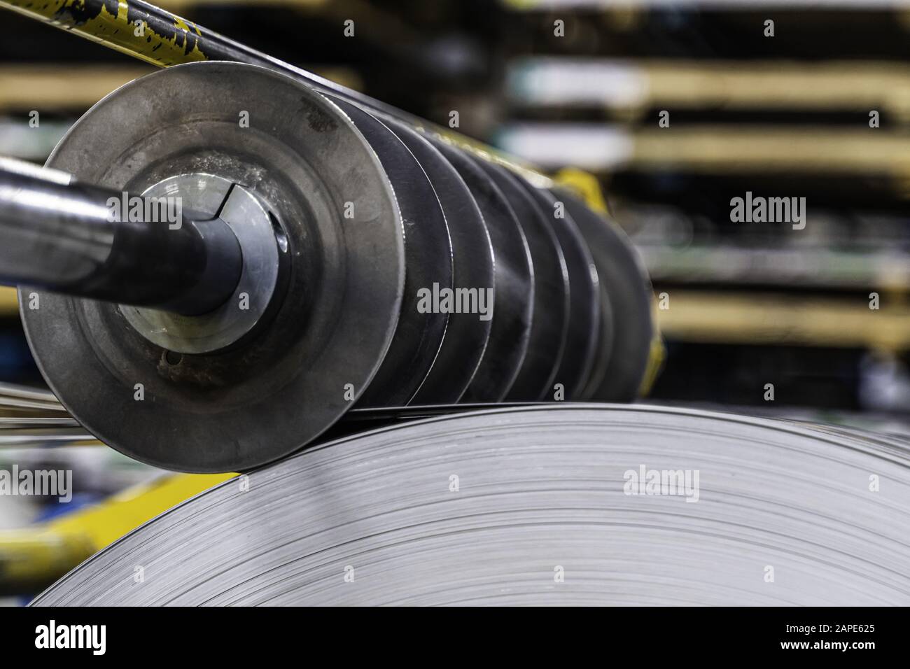 Metal blades cutting steel rolls into strips Stock Photo Alamy