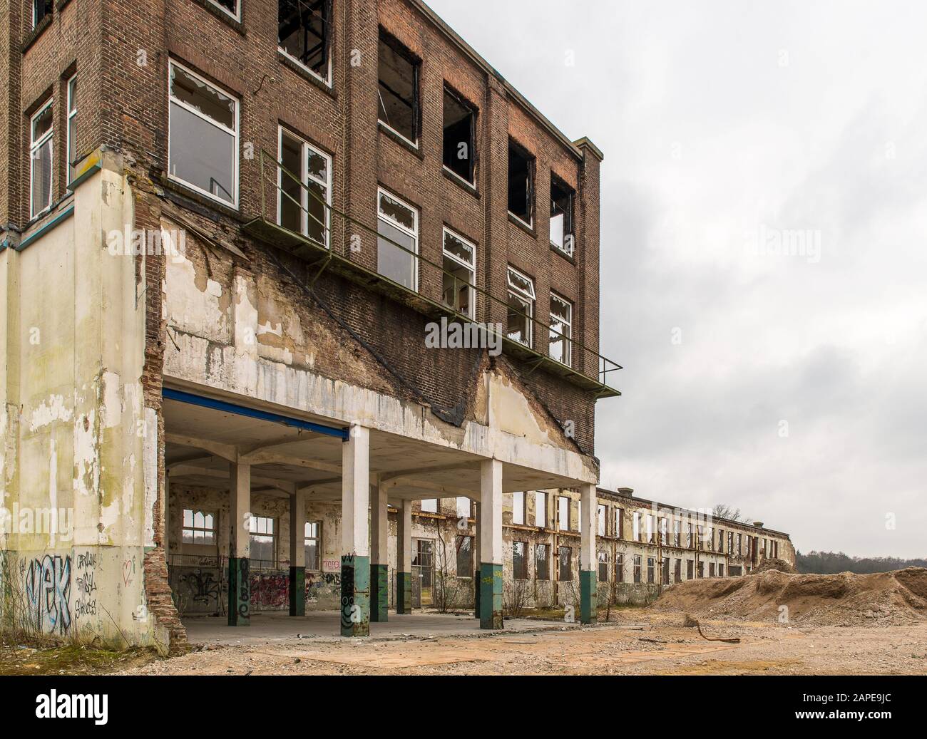 Abandoned old building with broken windows under a cloudy sky Stock ...