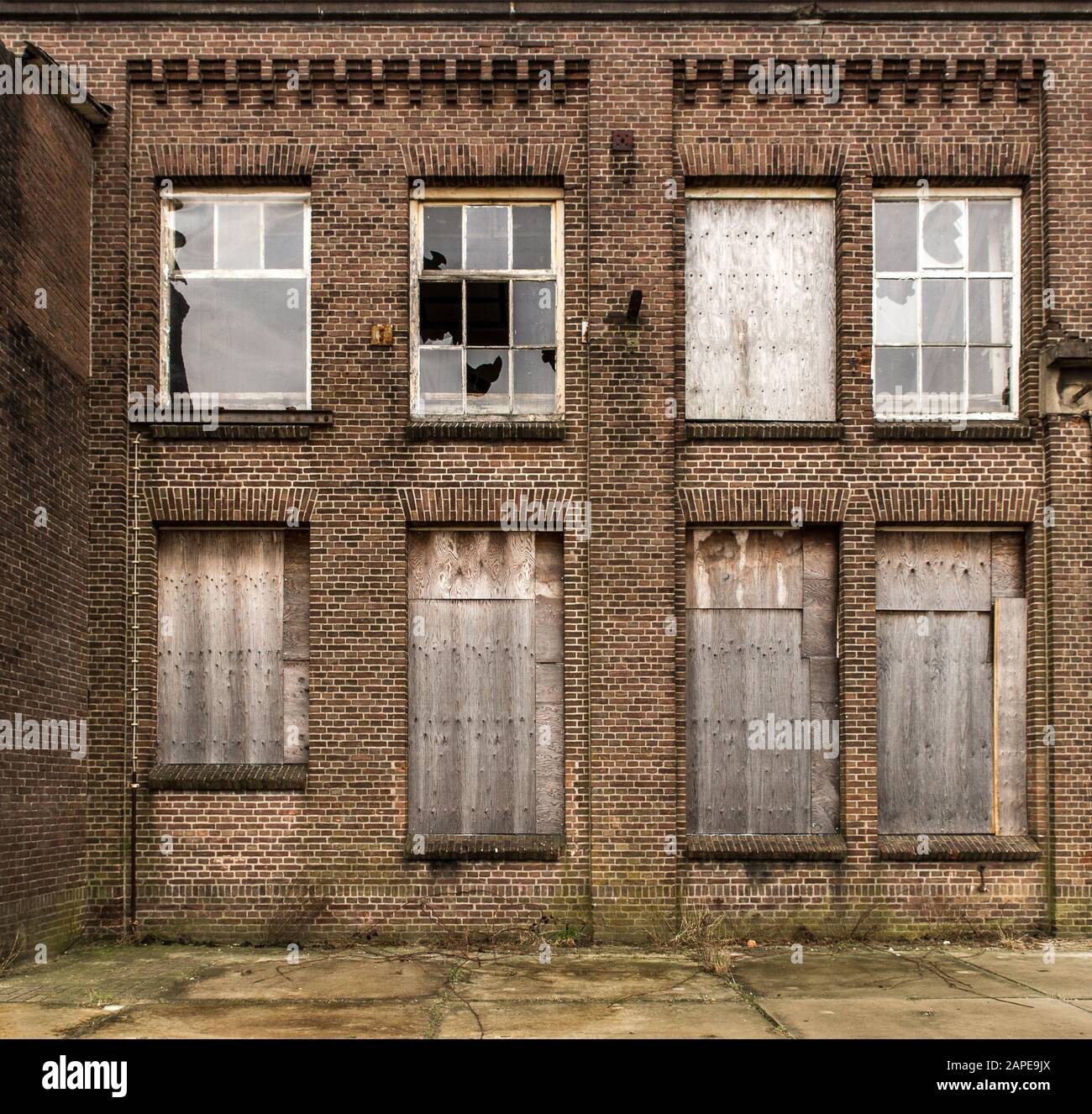 Old abandoned brick building with broken windows Stock Photo - Alamy