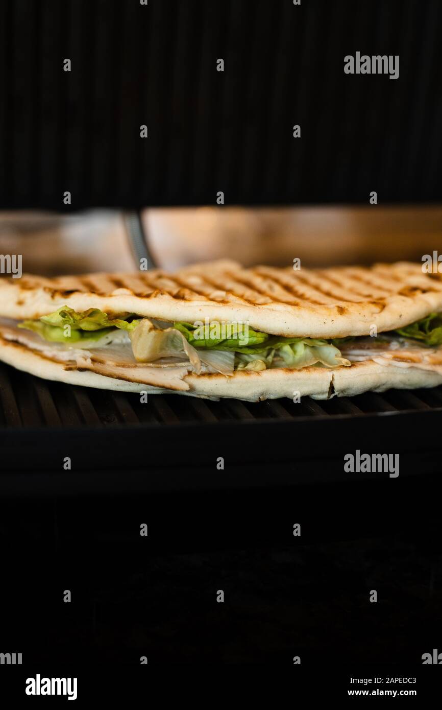 Panini grilled Pita bread, turkey meat, Swiss cheese, lettuce sandwich