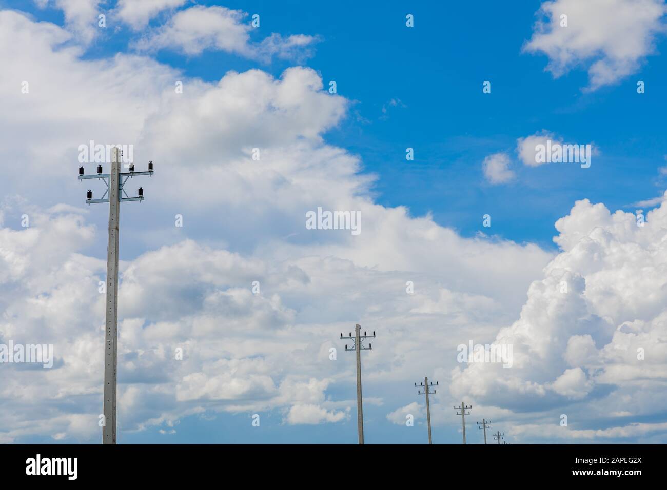 Electrical pole in blue sky background and white cloud Stock Photo - Alamy