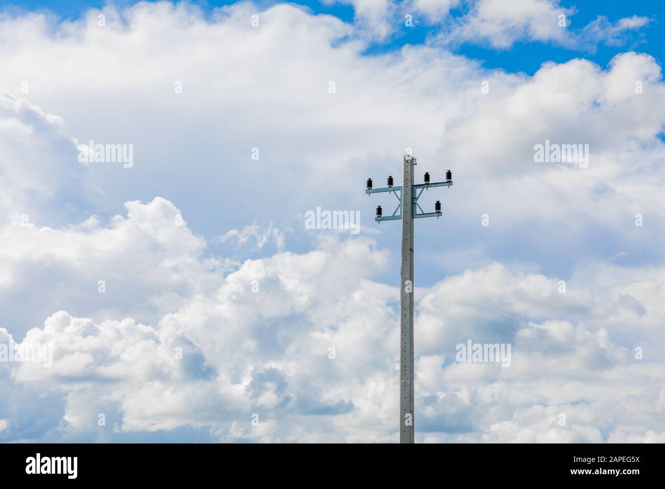 Electrical pole in blue sky background and white cloud Stock Photo - Alamy