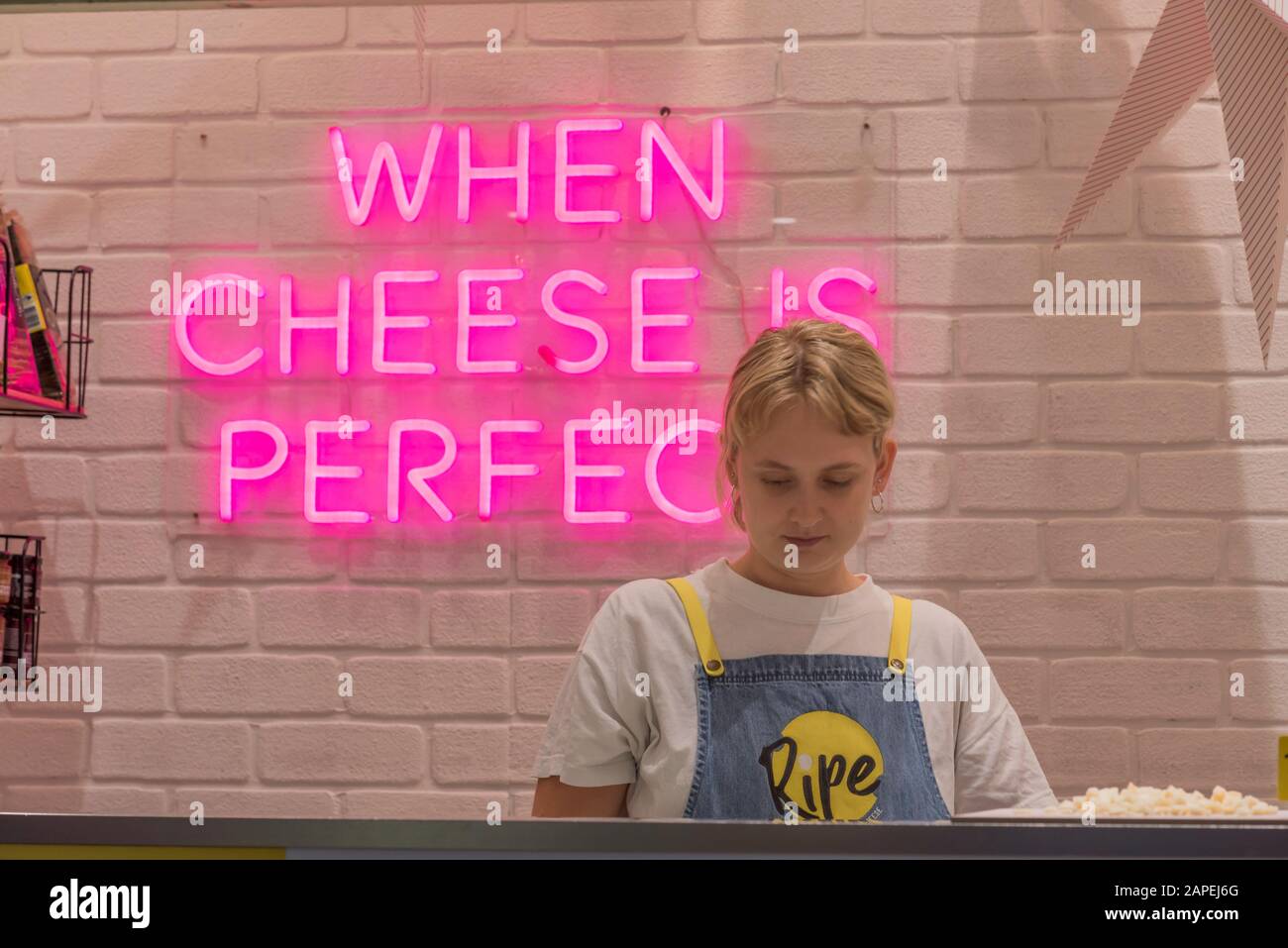 A young woman selling cheese at the indoor section of the famous Queen