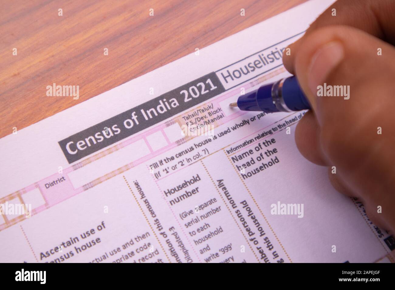 Maski, India 18,January 2020 - Close up of hands filling up the Census of India 2021 Form or NPR at house for population register at india. Stock Photo