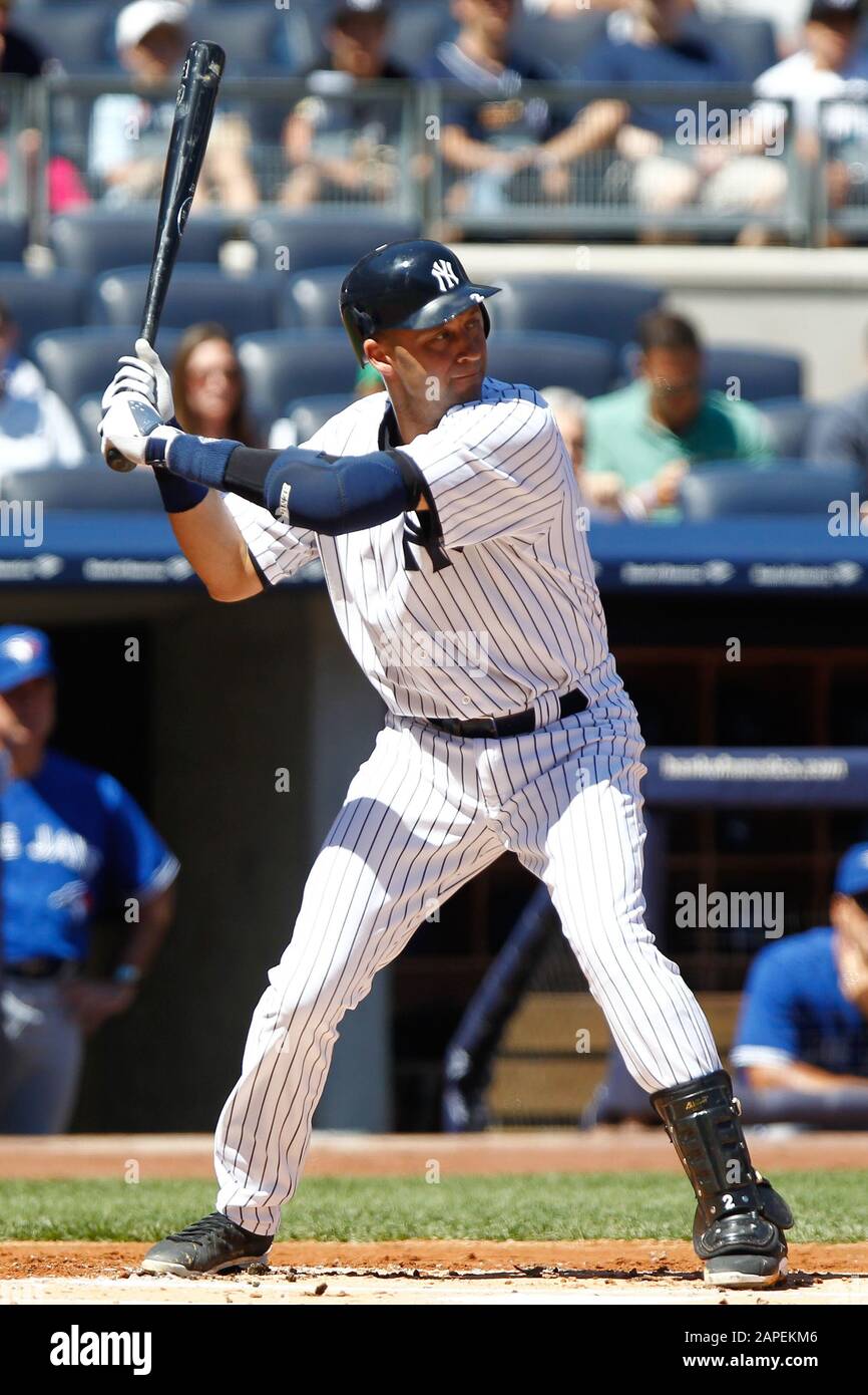BRONX, NY - AUG 29: New York Yankees shortstop Derek Jeter (2) singles to left against the Toronto Blue Jays on August 29, 2012 at Yankee Stadium. Stock Photo