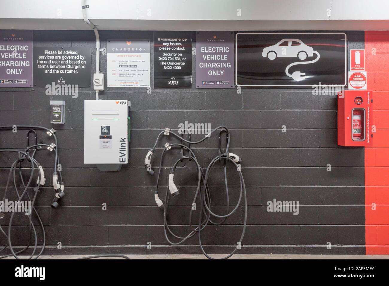 An electric vehicle EV car charging point in an underground car park in Sydney, Australia Stock Photo