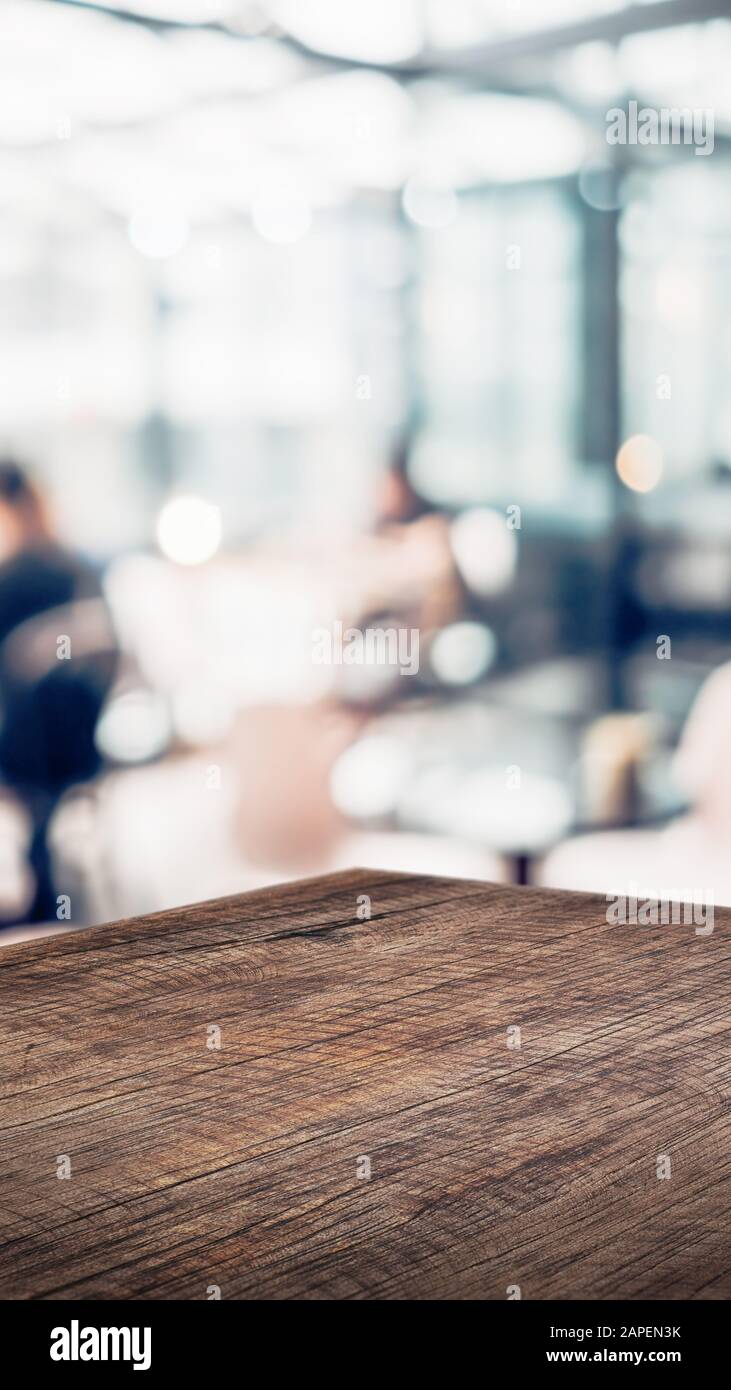 wood table product display background with blur people in cafe restaurant.customer dinning at perspective wooden kitchen counter.Banner mockup present Stock Photo