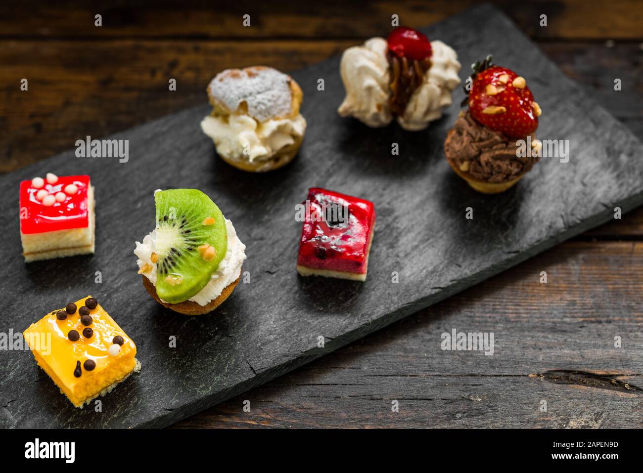 Selection of different dessert pastry sweet mini cakes and tartlets