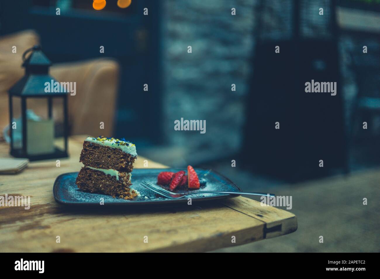 A cake with strawberries on a plate outdoors Stock Photo