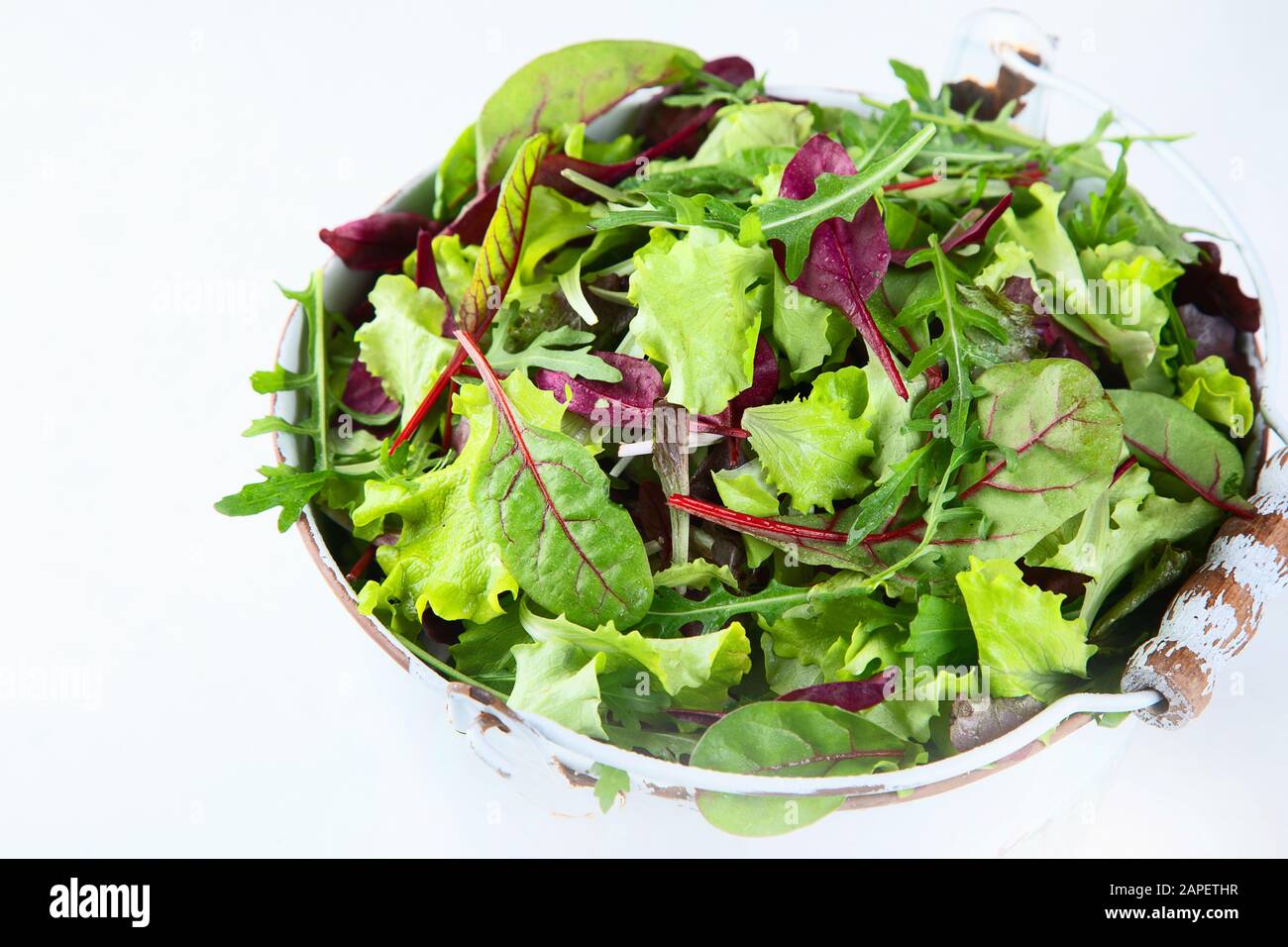 Mixed salad leaves. Healthy food background. Image with copy space