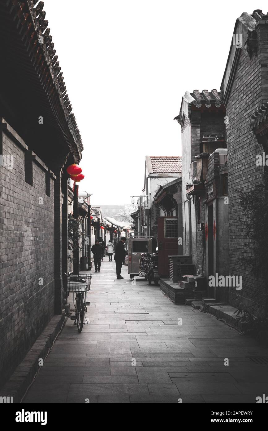 Decorated street / hutong / small alley in Beijing during the Chinese New Year, also referred to as the spring festival. With Rickshaw Stock Photo