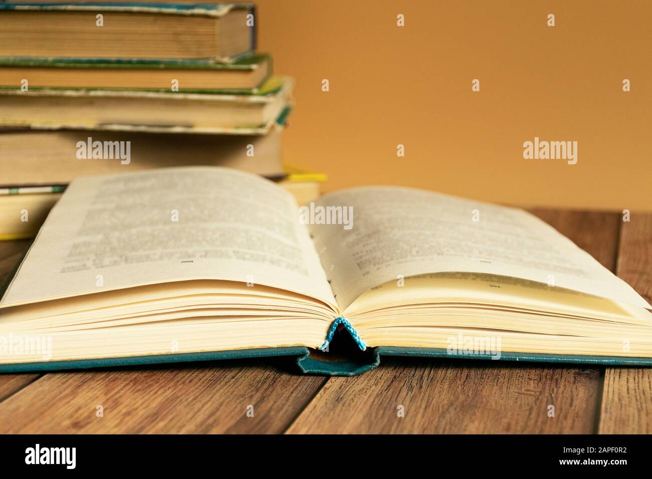 A stack of old books with yellow pages. Book binding. Knowledge and