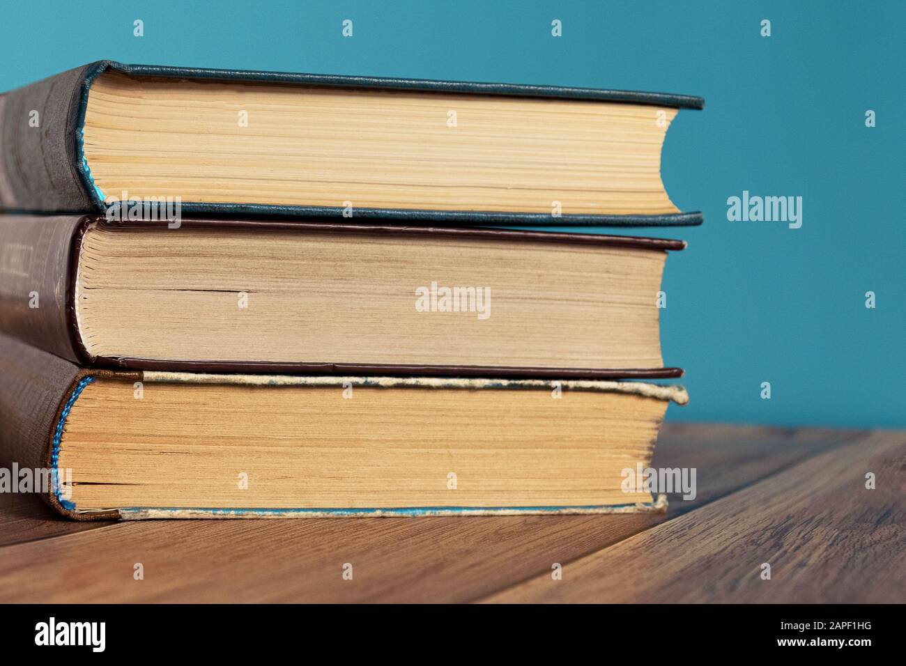 A stack of old books with yellow pages. Book binding. Knowledge and