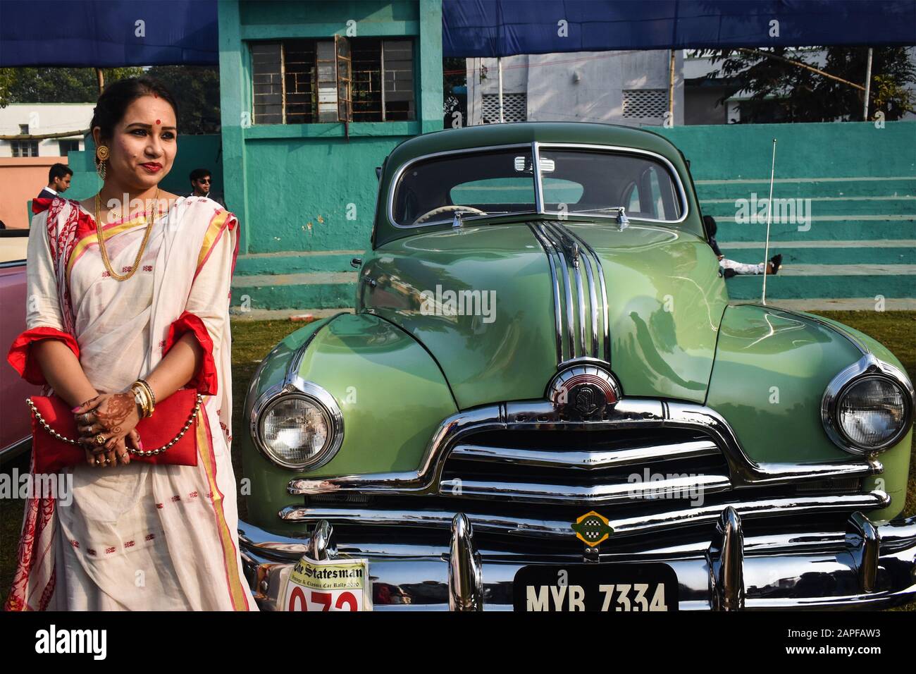 A women is standing with her vintage car in a vintage car rally in kolkata, India Stock Photo