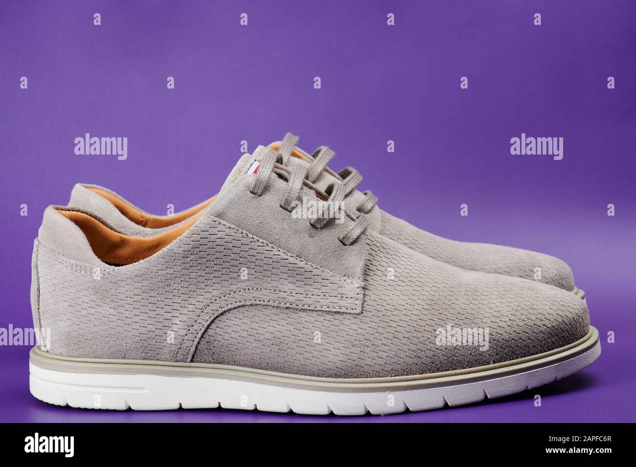 Side view of gray man shoes isolated on purple background Stock Photo