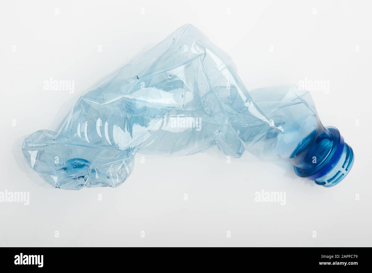 Recycled plastic waste theme. Blue plastic junk bottle Stock Photo