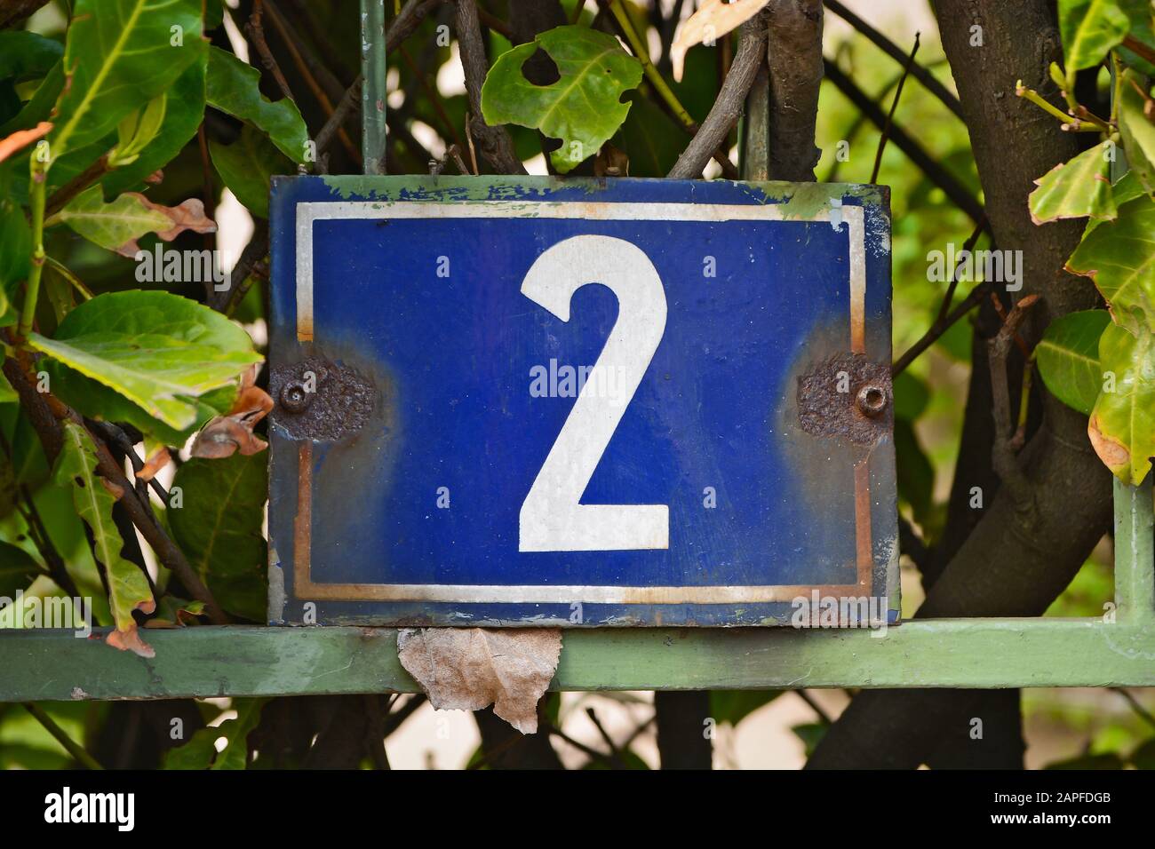 A house number plaque, showing the number two (2) Stock Photo
