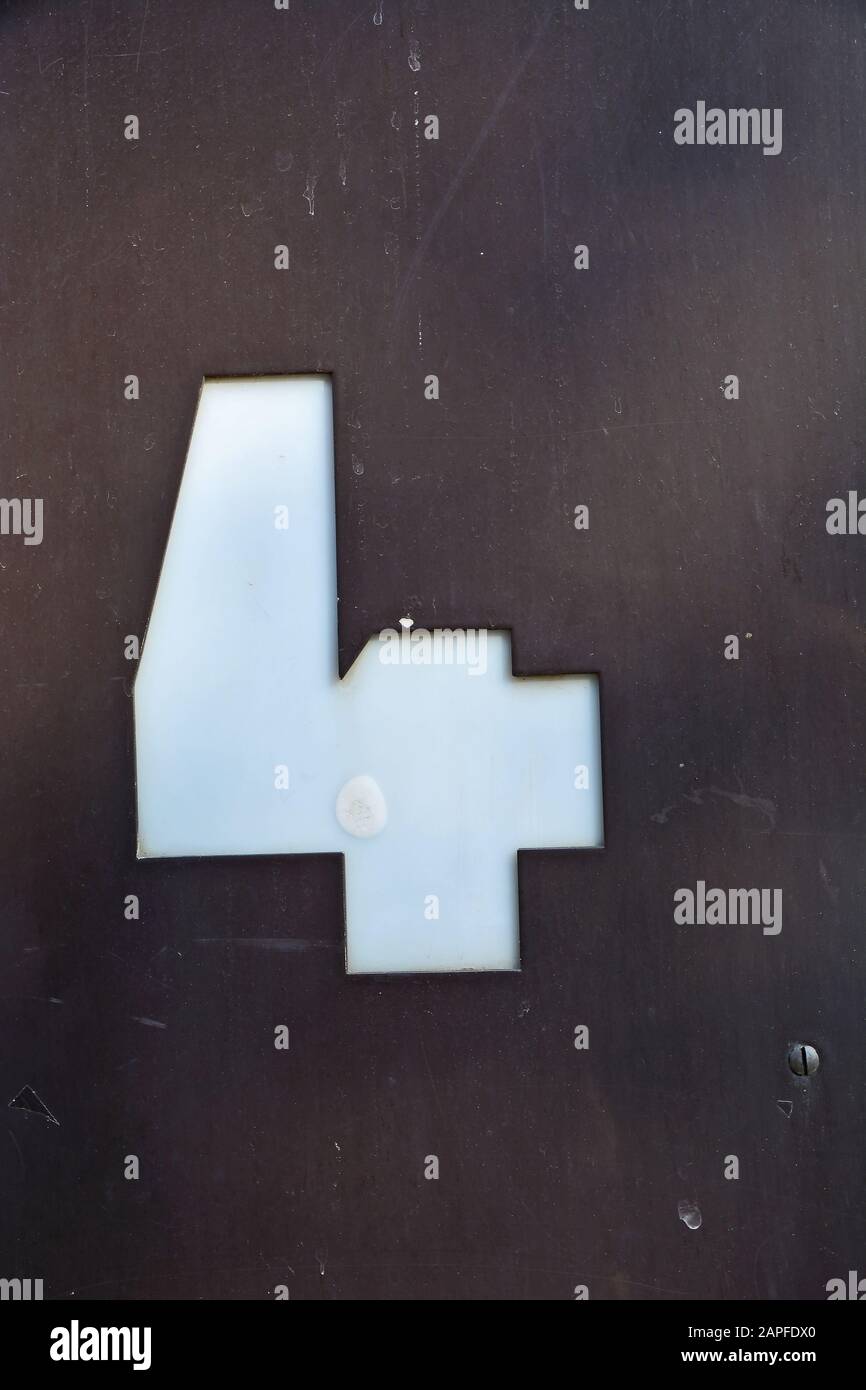 A house number plaque, showing the number four (4) Stock Photo