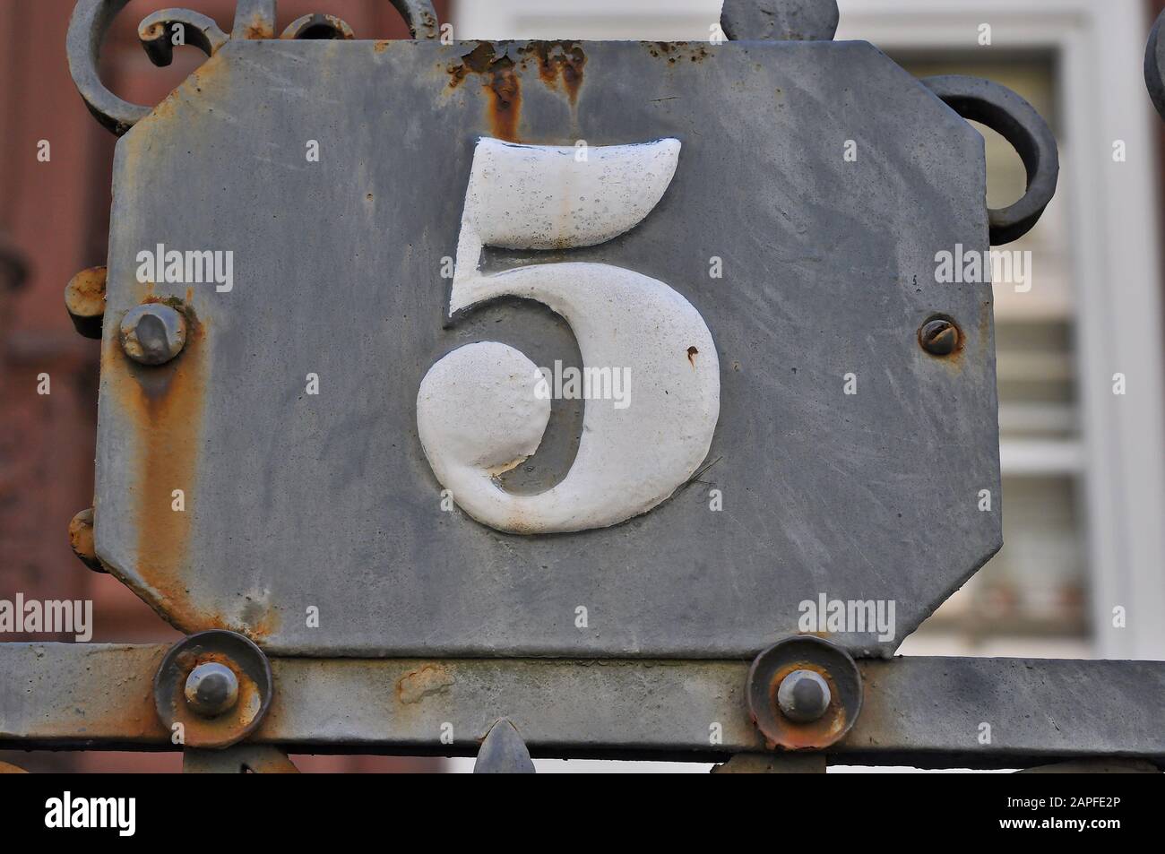 A house number plaque, showing the number five (5) Stock Photo