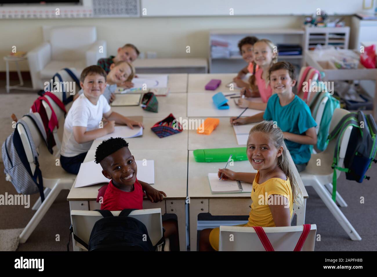 Group of schoolchildren working in an elementary school classroom Stock Photo