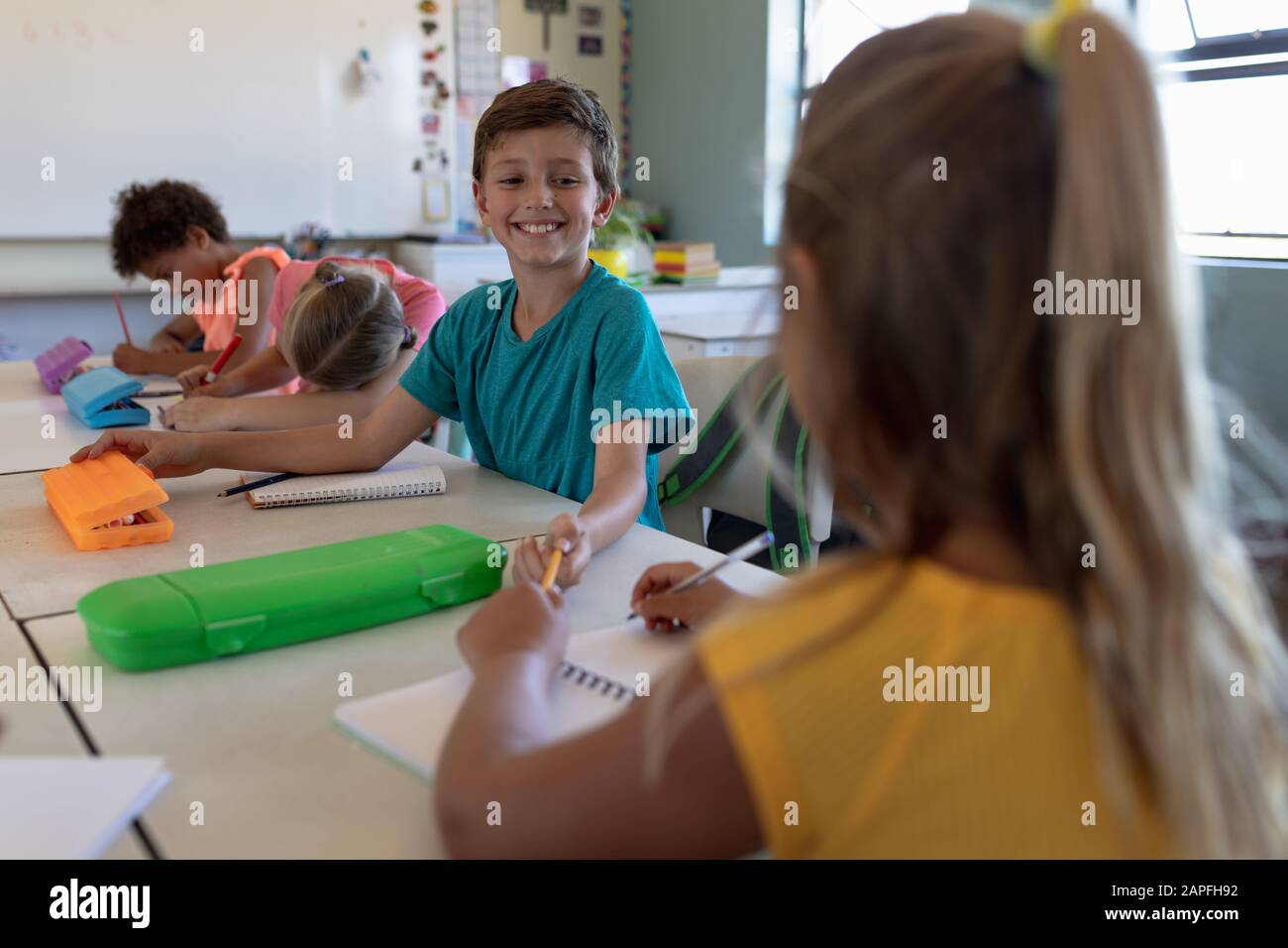 Schoolboy sitting at a desk in an elementary school classroom Stock ...