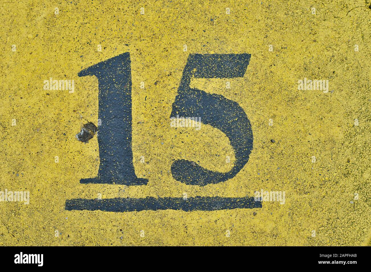A blue house number plaque, showing the white coloured number fifteen (15) Stock Photo