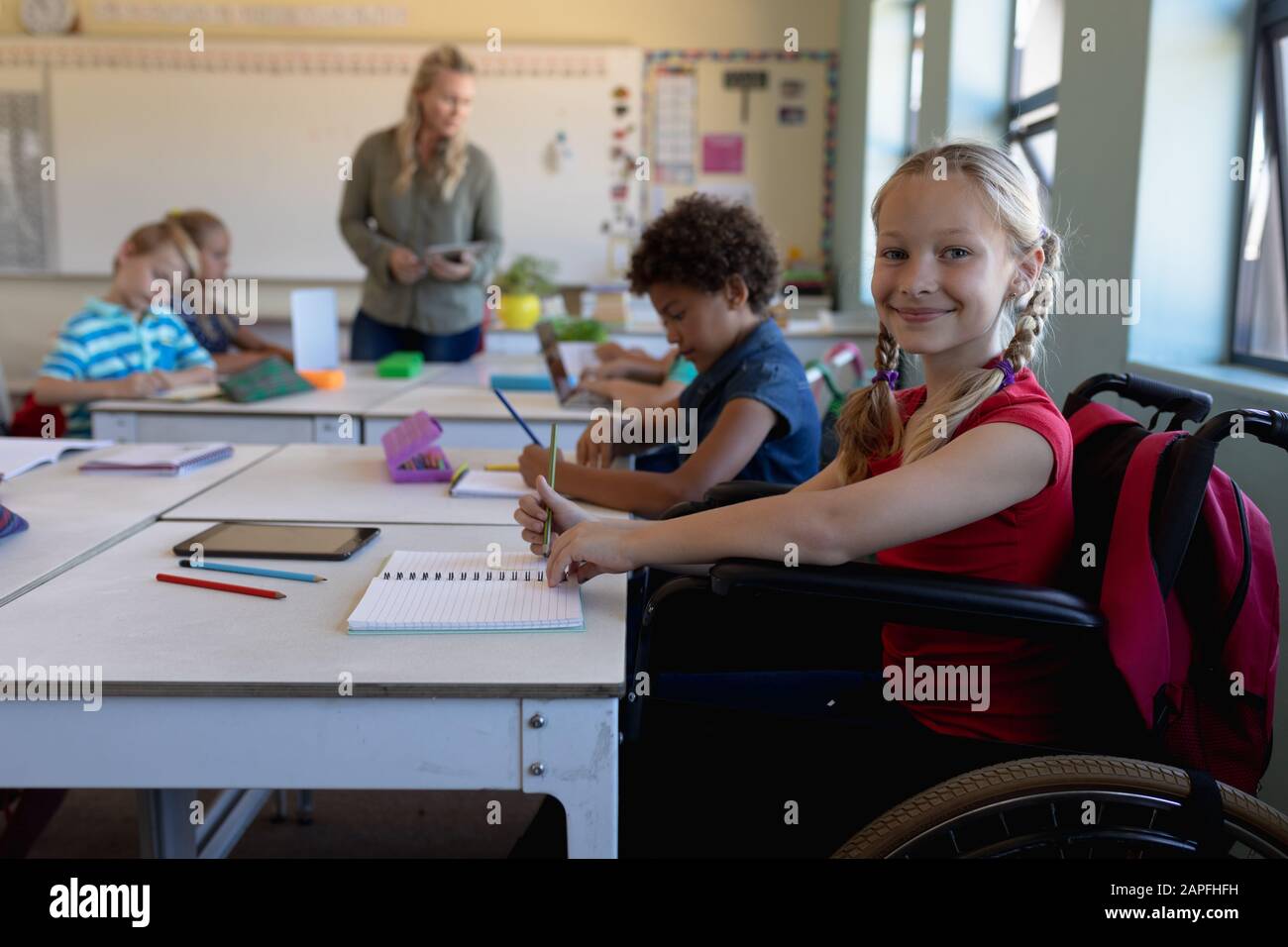 Schoolgirl sitting in a wheelchair in an elementary school classroom Stock  Photo - Alamy, image size:1300x956