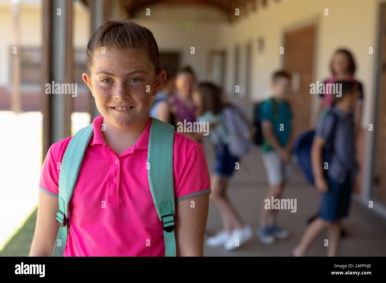 Schoolgirl standing in the schoolyard at elementary school Stock Photo