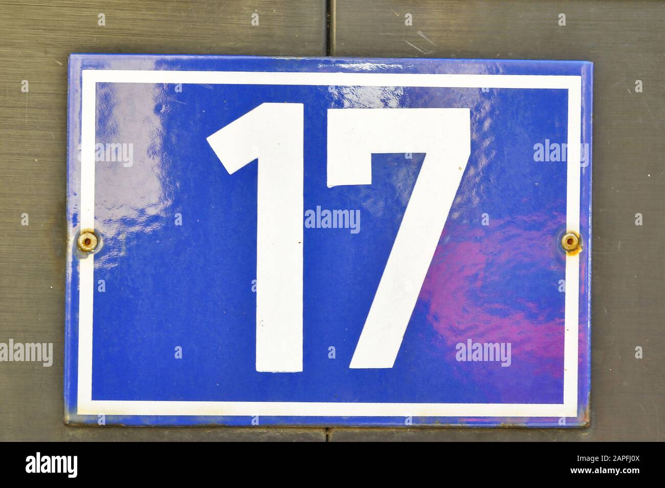 A house number plaque, showing the number seventeen (17) Stock Photo