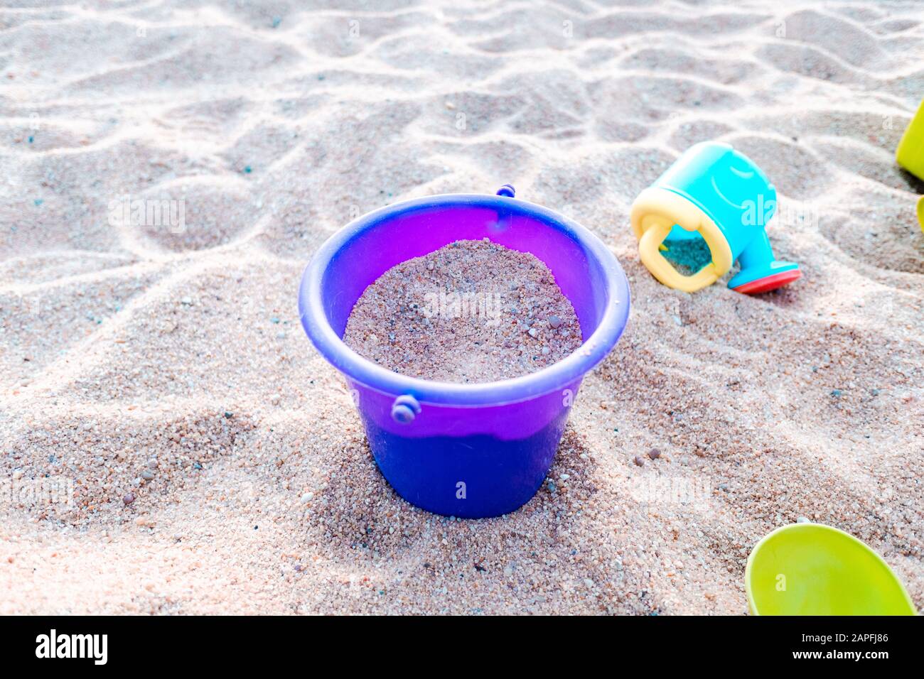 Plastic toy buckets and shovels in a sandbox Stock Photo Alamy