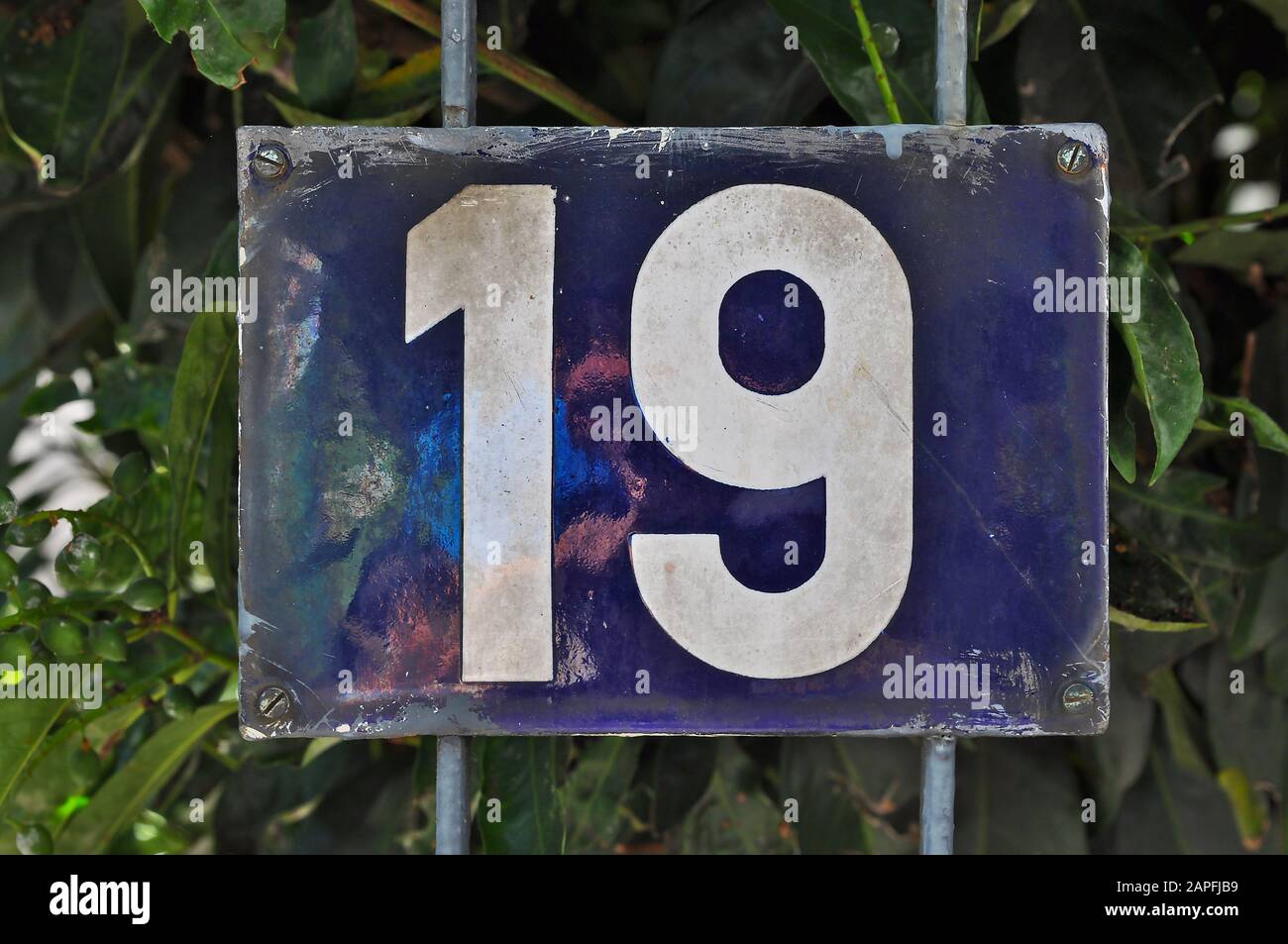 A house number plaque, showing the number nineteen (19) Stock Photo