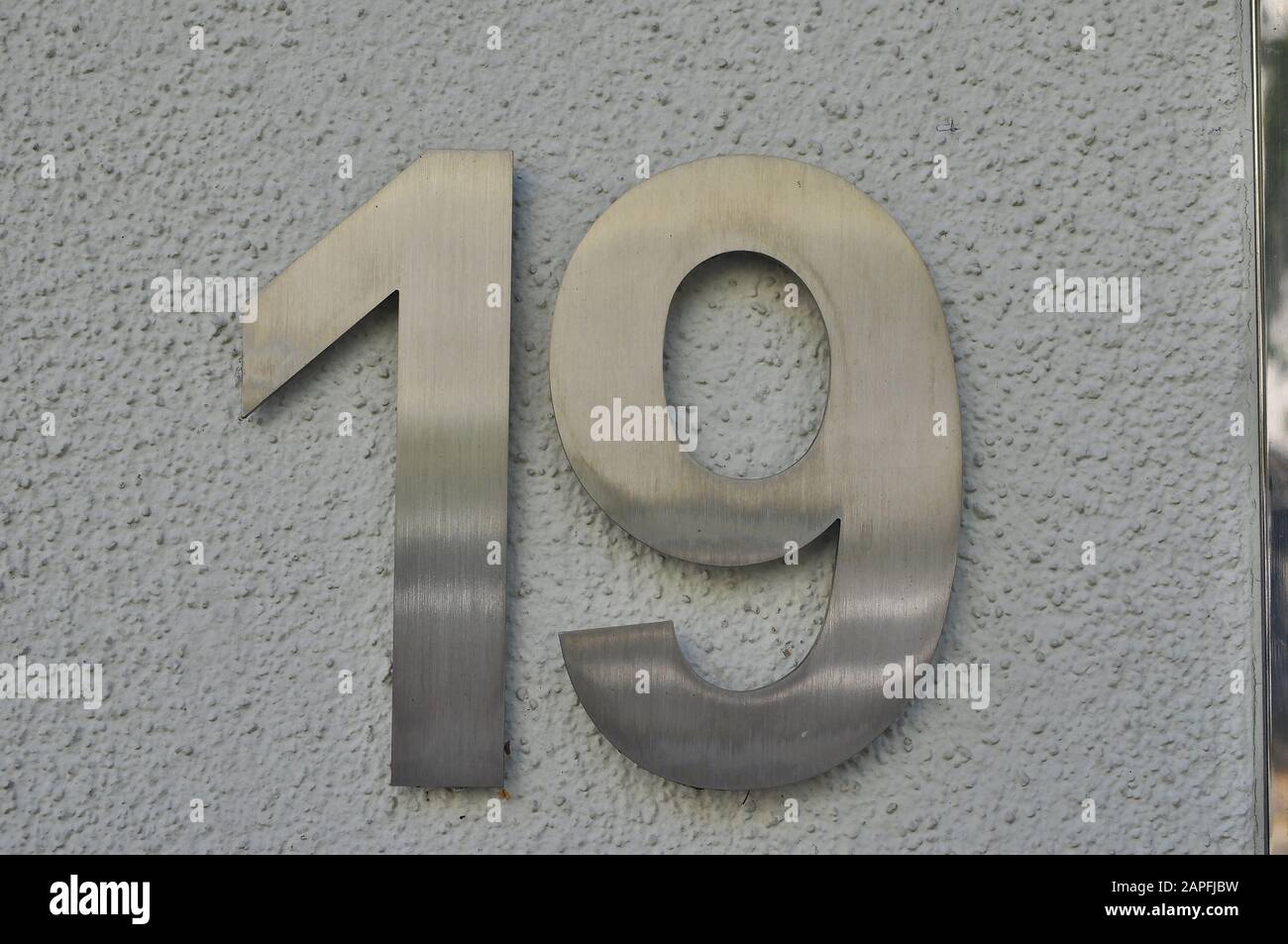 A house number plaque, showing the number nineteen (19) Stock Photo