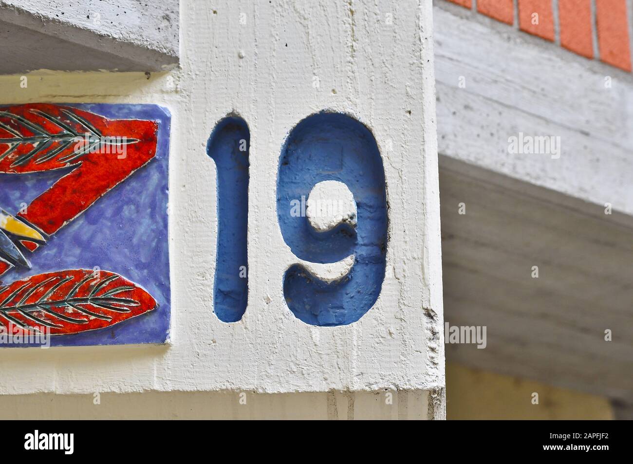 A house number plaque, showing the number nineteen (19) Stock Photo