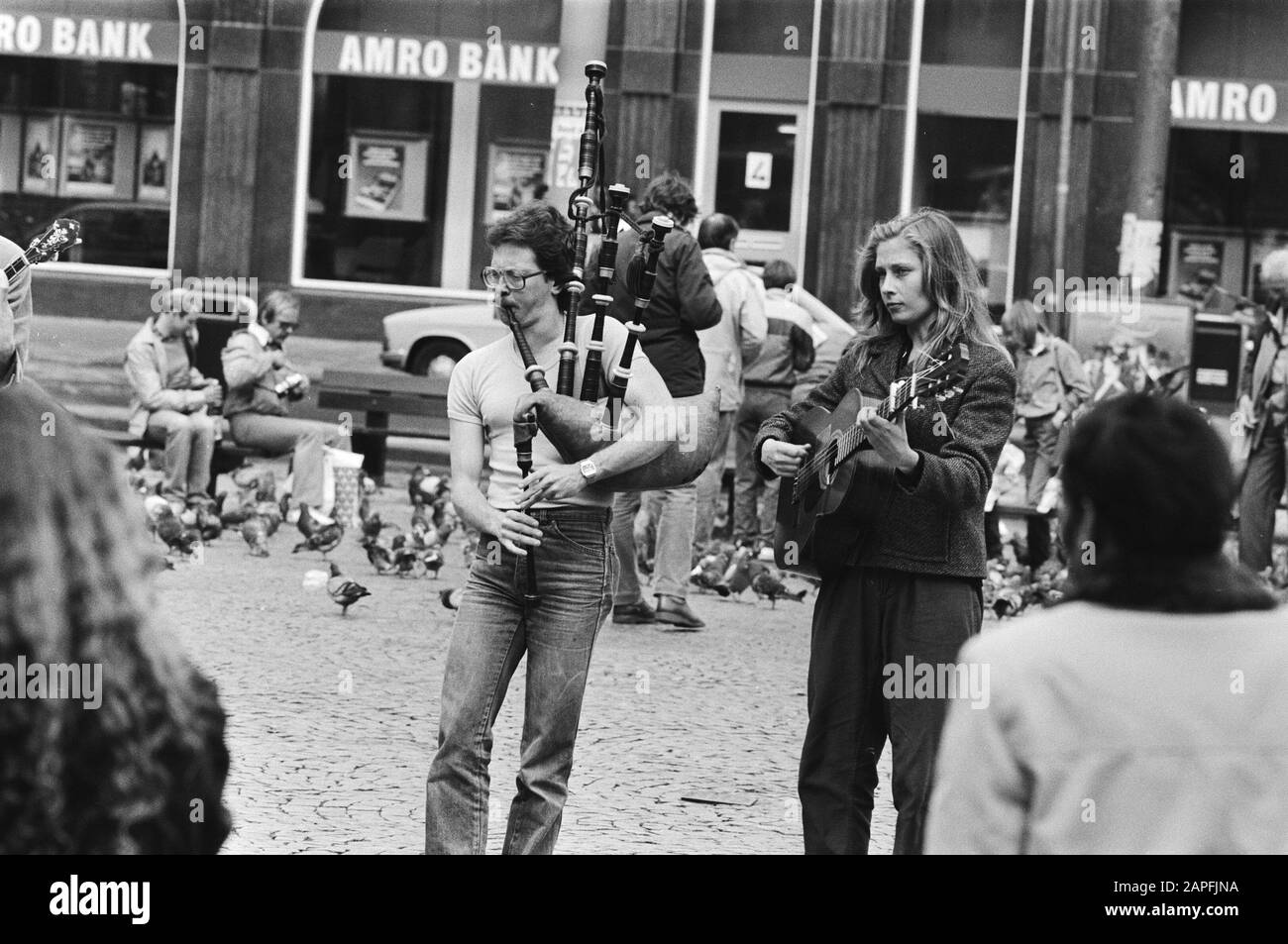 Pentecost tourism is getting under way Description: Foreign street musicians with bagpipes and guitar in Amsterdam Date: 19 May 1983 Location: Amsterdam, Noord-Holland Keywords: holidays, musical instruments, street artists, street images Stock Photo