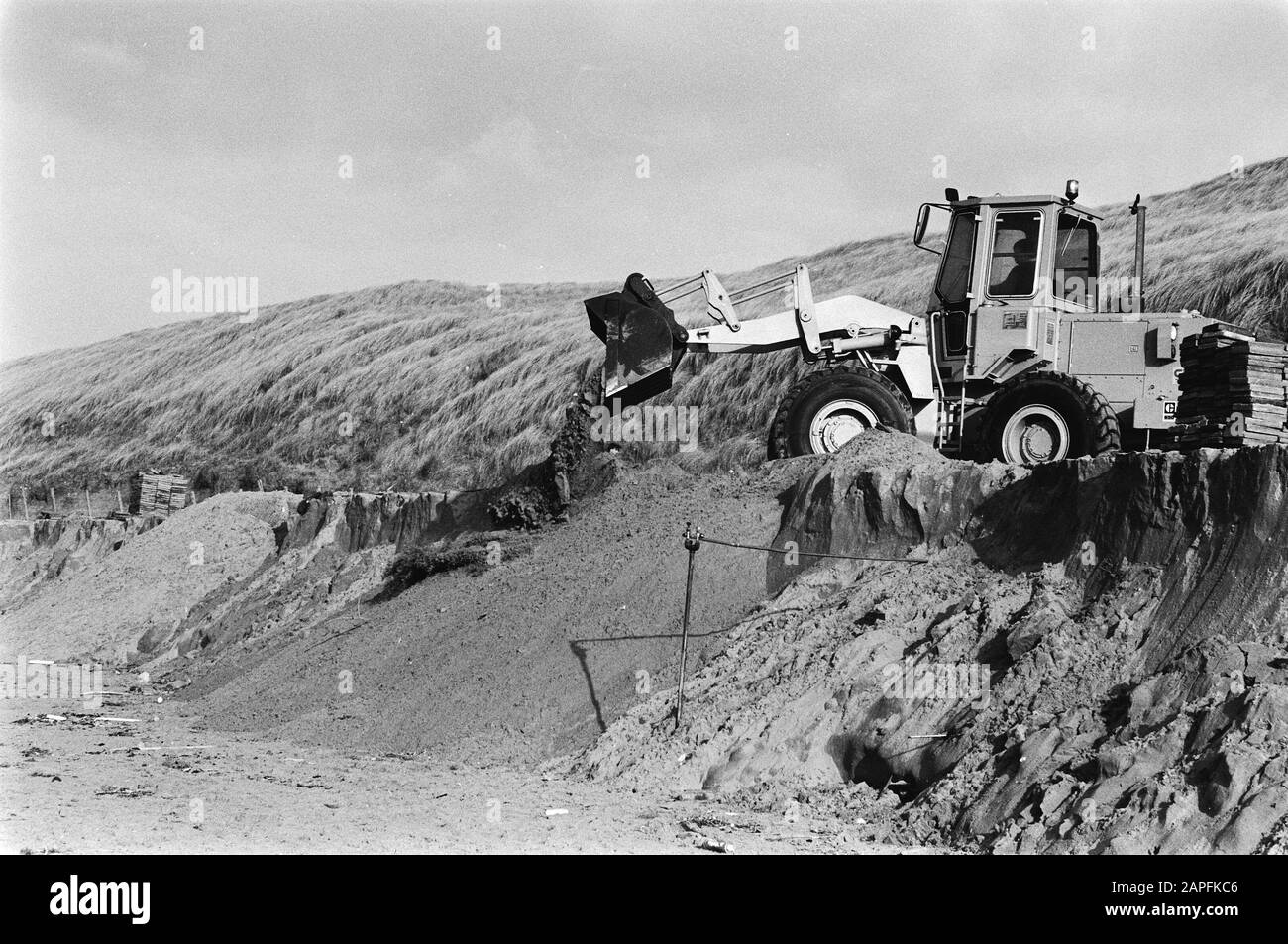 Strand near Bloemendaal after a heavy storm Description: Bulldozer on the beach repairing the damage Date: February 2, 1983 Location: Bloemendaal, Noord-Holland Keywords: dunes, excavators Stock Photo