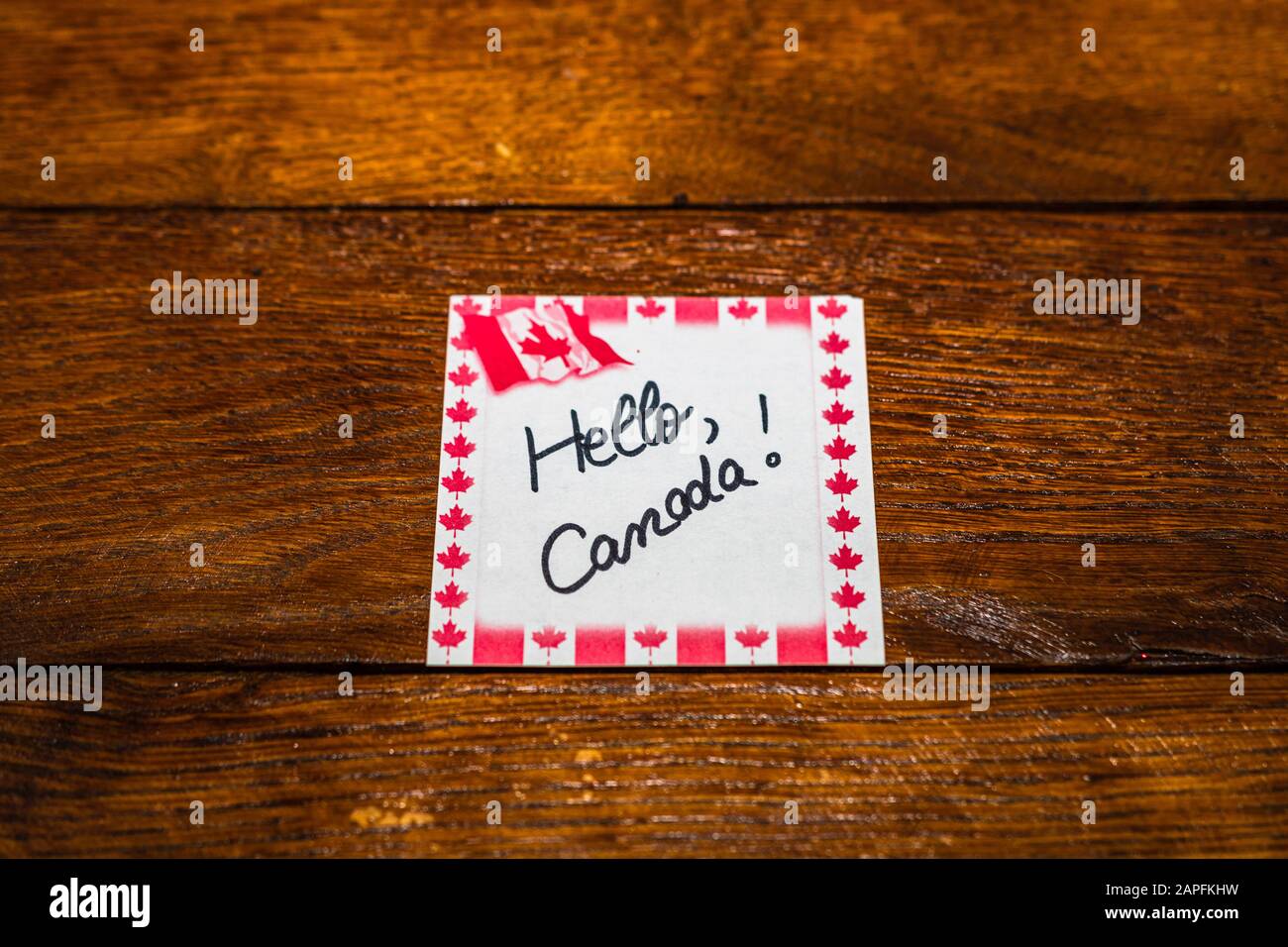 Hello, Canada. handwriting text on memo post reminder with Canada flag ...