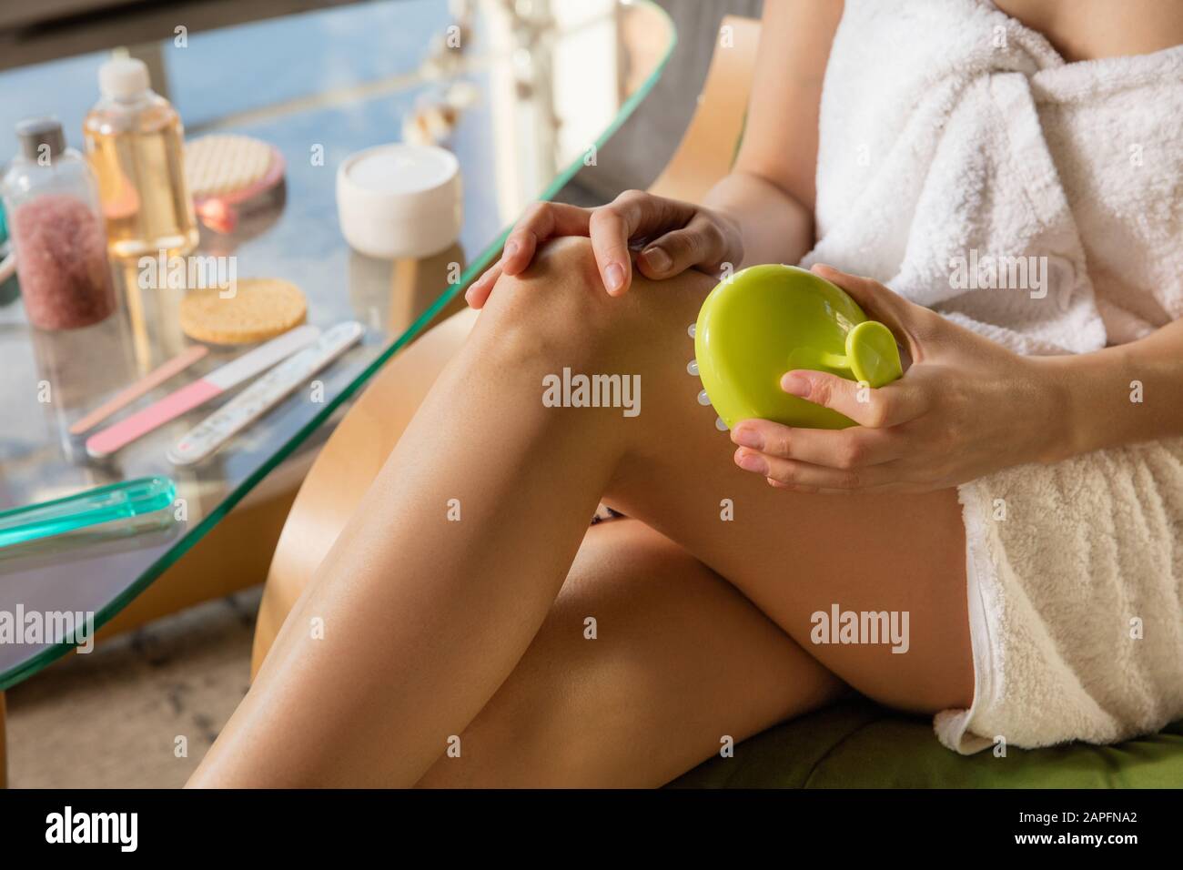 Beauty Day. Woman wearing towel doing her daily skincare routine at home.  Putting on moisturizing, doing anti-cellulite, lymphatic drainage massage.  Concept of beauty, self-care, cosmetics, youth Stock Photo - Alamy