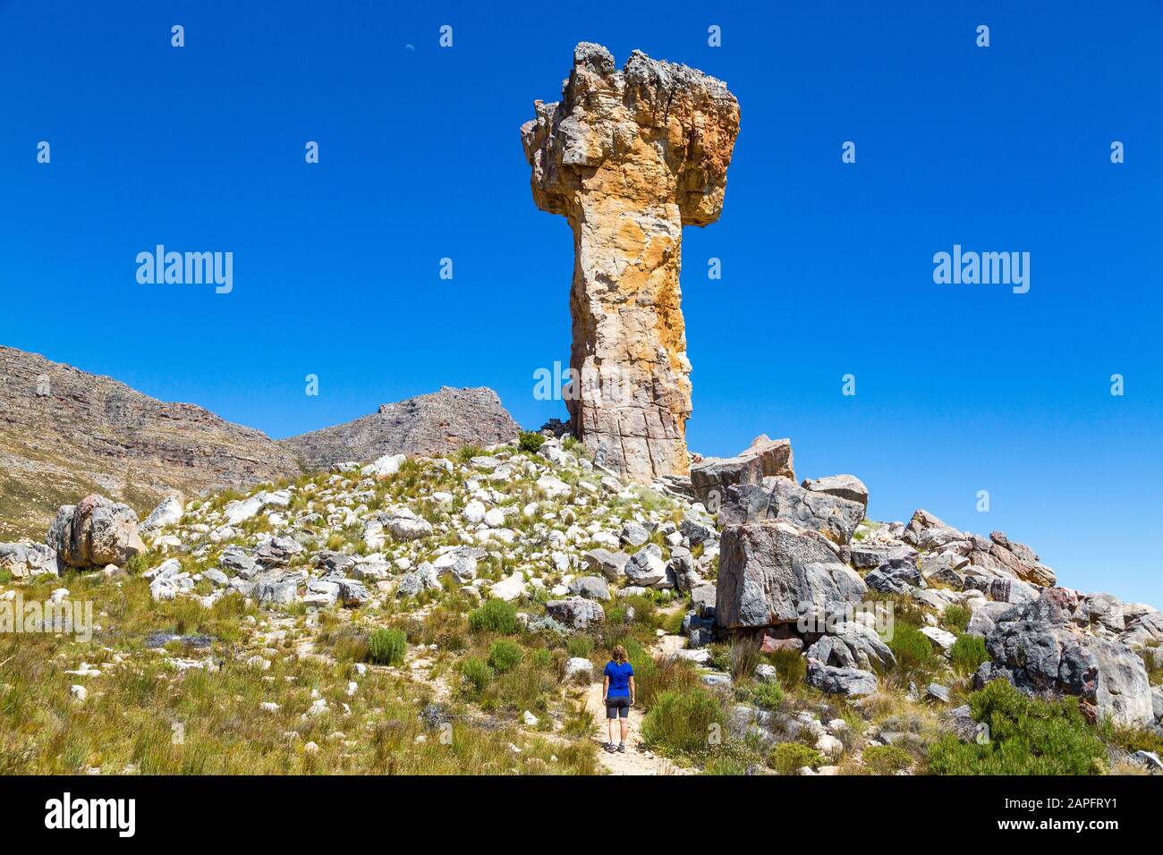 Woman looking at the rock formation Maltese Cross - a popular hiking destination in the Cederberg, South Africa Stock Photo