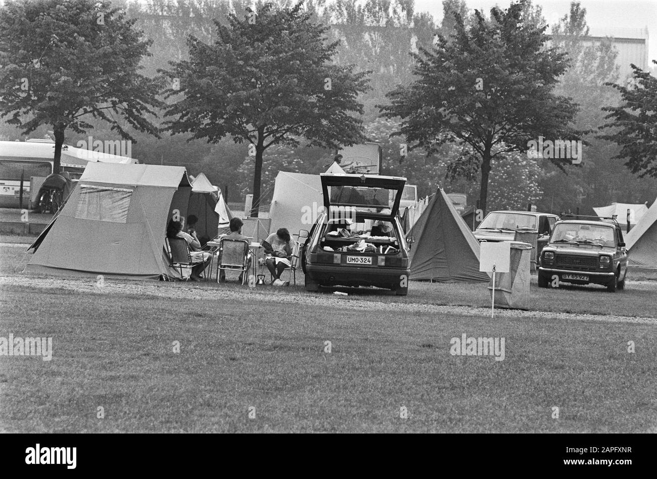 Start of the holiday exodus Description: Camping guests in front of their tent next to a fully loaded car Date: June 24, 1983 Keywords: campsites, tents, holidays, summer Stock Photo