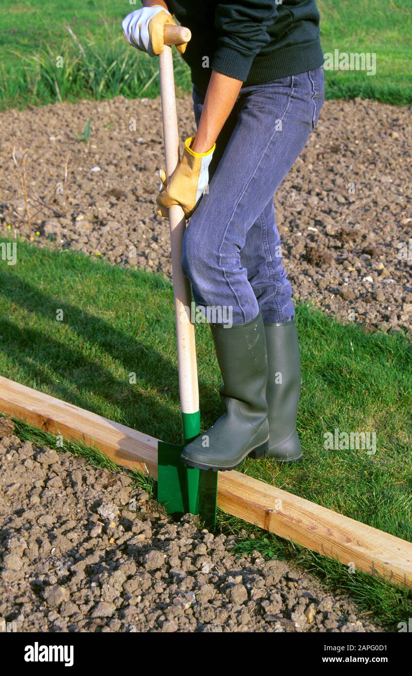 Cutting the edge of grass in the spring Stock Photo Alamy