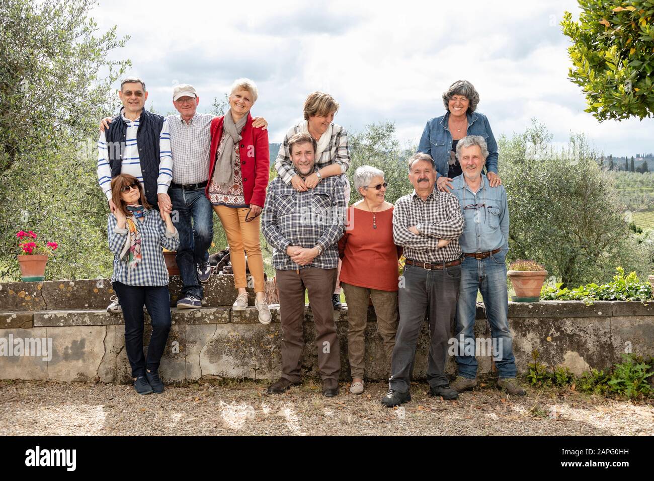 Portrait of senior couples, olive trees in background, Florence, Italy Stock Photo