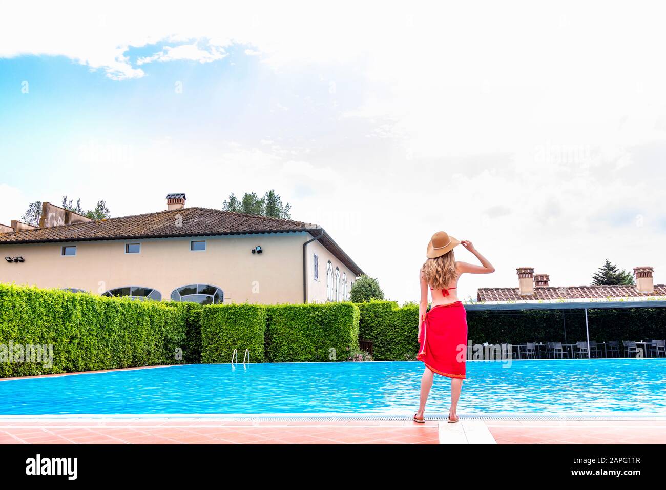 Woman in red bikini by swimming pool Stock Photo - Alamy