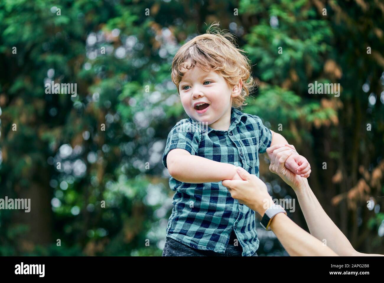 Mother playing with toddler in park Stock Photo