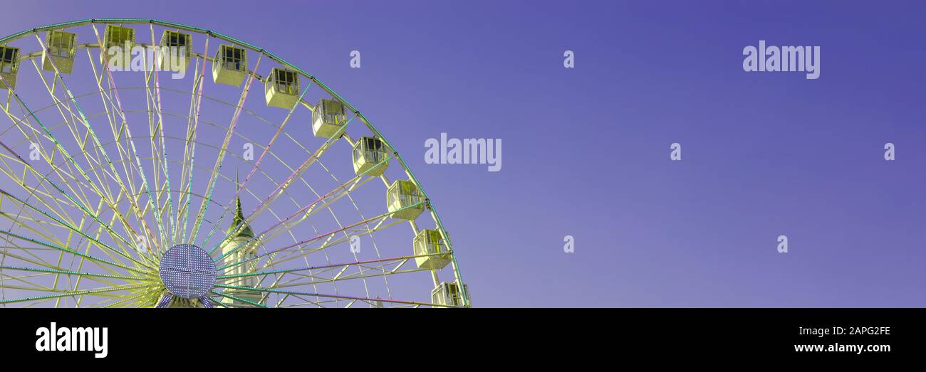 Ferris wheel on the background of purple sky. Banner Stock Photo