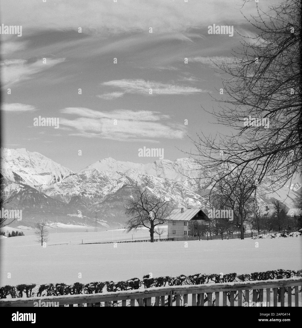 Winter in Tyrol Description: Chalet house in the snow with in the background the Karwendel Mountains Date: January 1960 Location: Austria, Sistrans, Tyrol Keywords: mountains, landscapes, snow, winter, housing Stock Photo