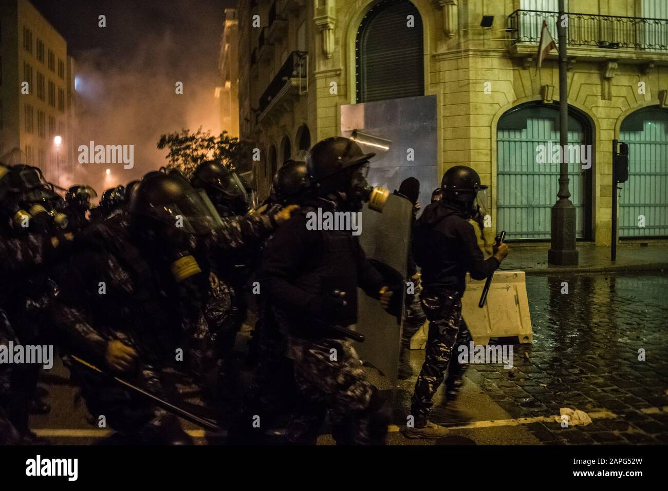 Beirut, Lebanon. 22nd Jan, 2020. Police charge protesters reacting to interim prime minister Hassan Diab's finalisation of a new cabinet for Lebanon, as riots break out in the Downtown area. Credit: Elizabeth Fitt/Alamy Live News Stock Photo