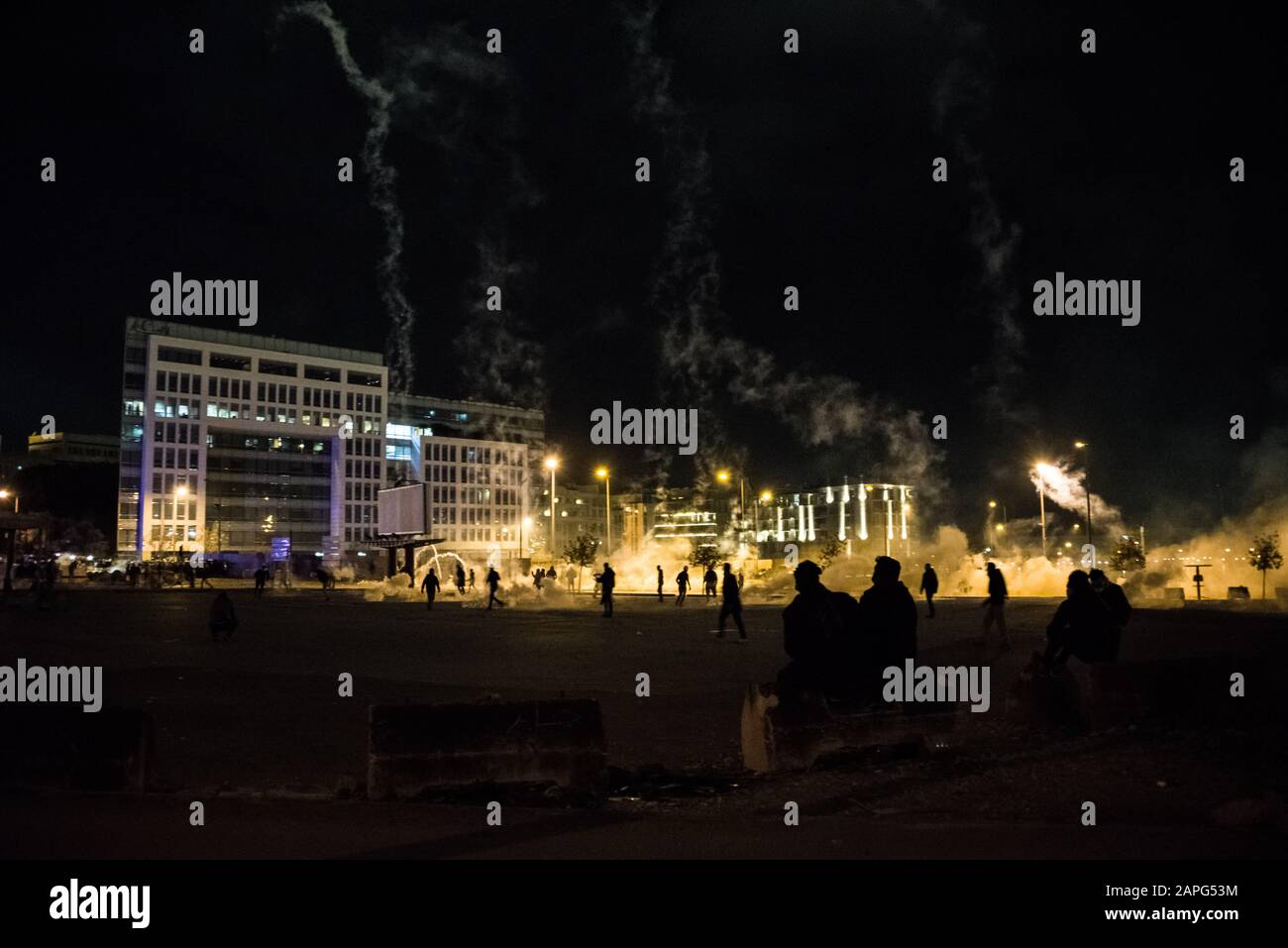 Beirut, Lebanon. 22nd Jan, 2020. Spectators watch as a rain of tear gas hits protesters in Martyrs Square following Hassan Diab's finalisation of a new cabinet for Lebanon. Credit: Elizabeth Fitt/Alamy Live News Stock Photo