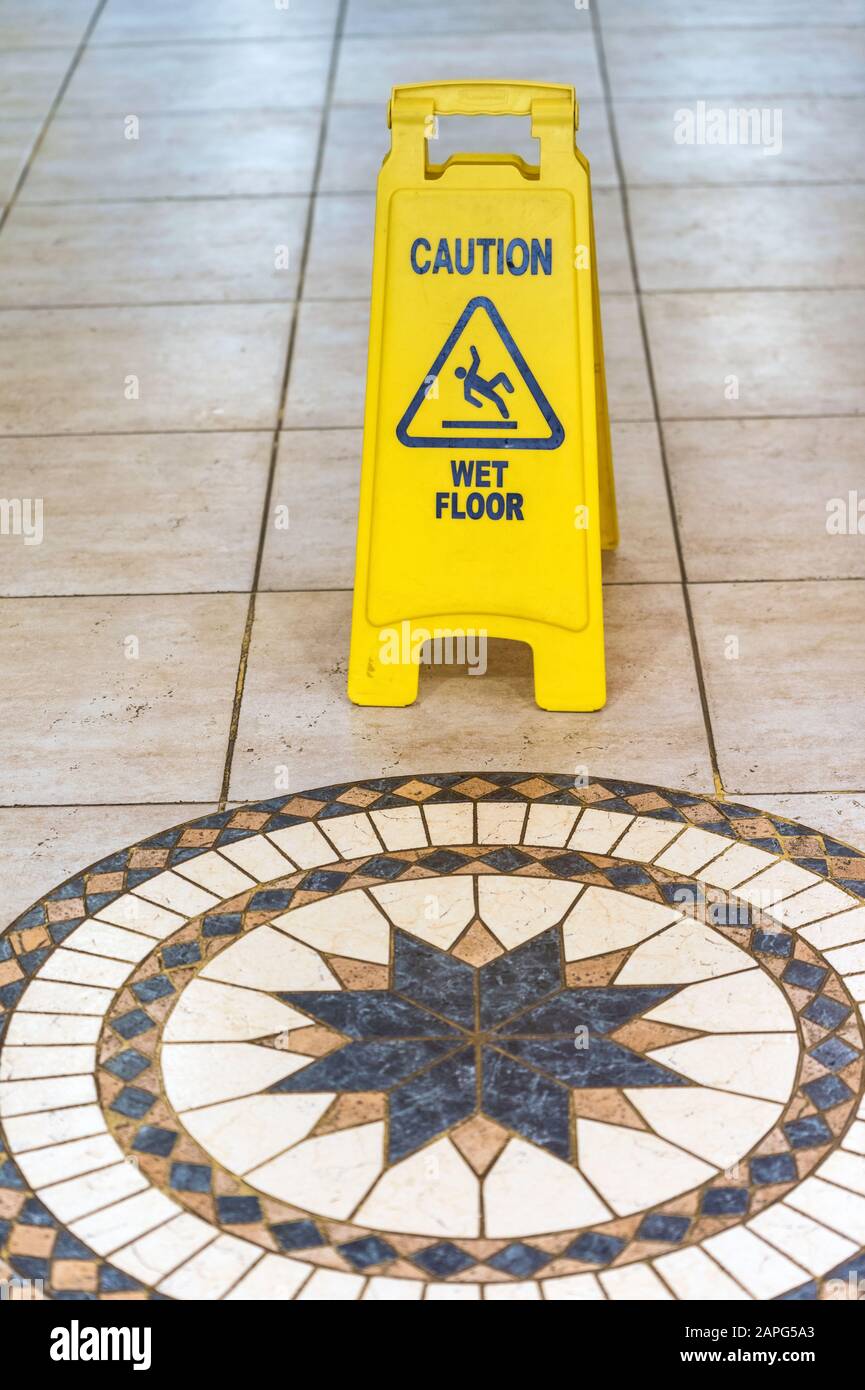 Wet floor caution sign in the hotel Stock Photo - Alamy